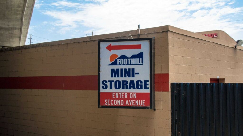Exterior signage for Foothill Mini Storage with an arrow to the entrance