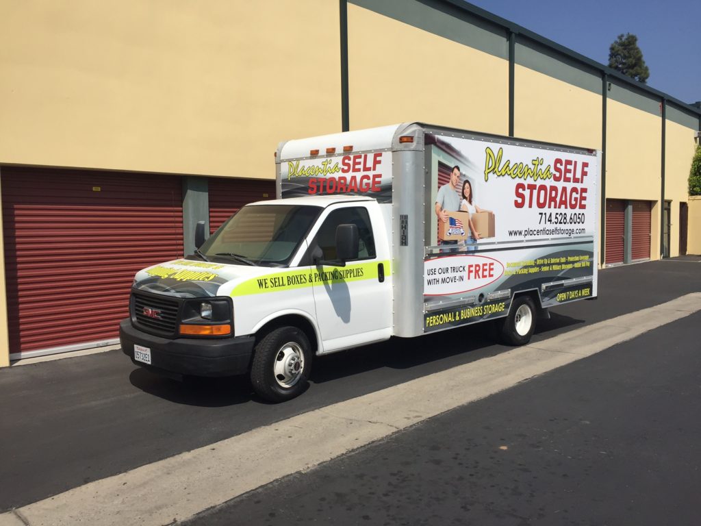 A Placentia Self Storage moving truck parked outside of outdoor storage units